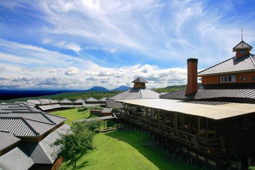 an overhead view of a large building with a grass yard at Resonate Club Kuju in Taketa