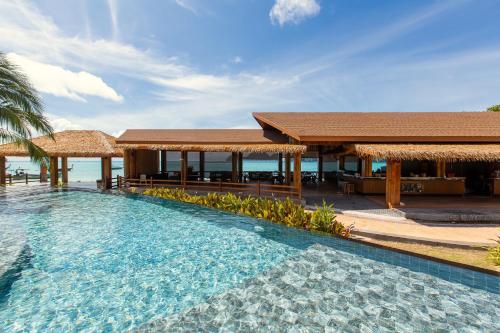 a swimming pool in front of a resort at U Rip Resort in Phi Phi Islands