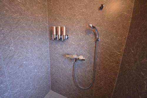 a shower with a shower head in a bathroom at Daigo - Vacation STAY 04957v in Kanayama