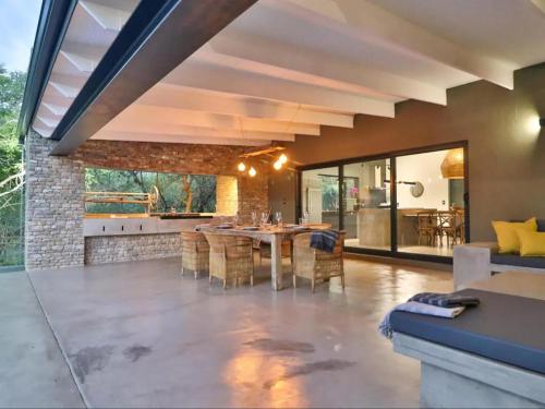 a kitchen and dining room with a table and chairs at Chelesa by Kruger Nights in Marloth Park