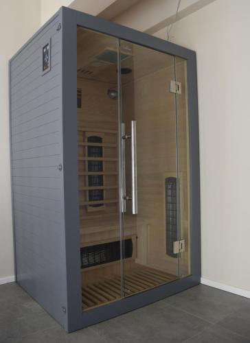 a large glass enclosure in a room at Nowa Kamienica 11 in Stara Kamienica