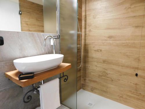 a bathroom with a sink and a shower at NicoMat Rooms in Domodossola