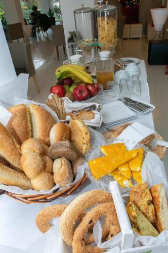 a table topped with baskets of bread and fruit at Leto Boutique Hotel Agrinio in Agrinion