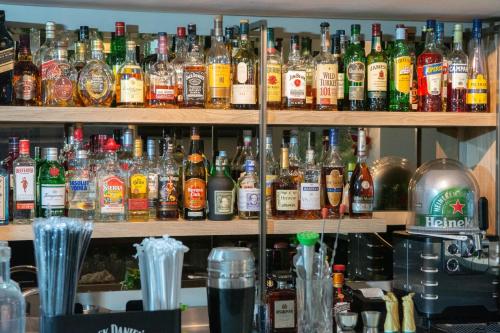a bar filled with lots of bottles of alcohol at Leto Boutique Hotel Agrinio in Agrinion