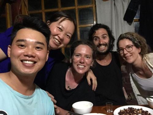 a group of people posing for a picture at a table at ChienDe Homestay in Sa Pa
