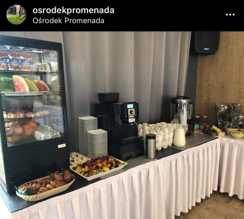 a buffet with food on a table with a refrigerator at Ośrodek Promenada- Faleza in Jastrzębia Góra