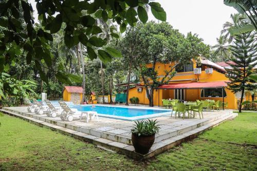een zwembad met stoelen en tafels en een huis bij Casa De Piscina by LivingStone in Majorda