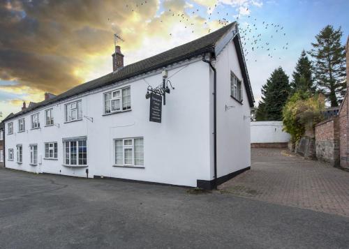 a white building with a lot of windows at Donington Cottage Apt 5 in Castle Donington