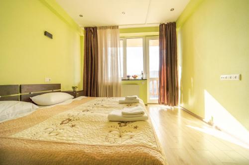 sypialnia z dużym łóżkiem i dużym oknem w obiekcie 2-room Apartment NFT Gudauri Penta 501 w mieście Gudauri