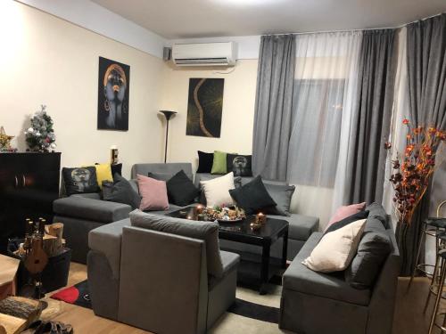 a living room with a couch and a table at Sunshine villa Dzhigurovo in Sandanski