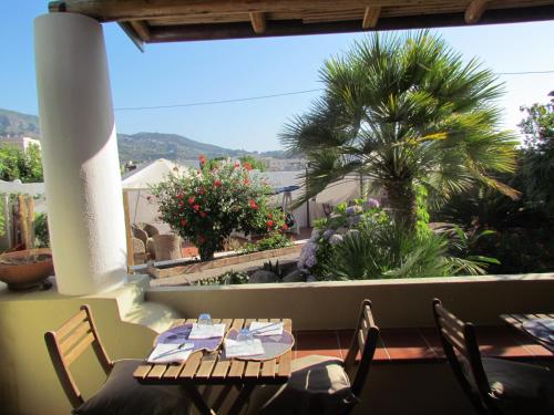 a restaurant with a view of a balcony with tables and chairs at B&B Il Cappero in Lipari