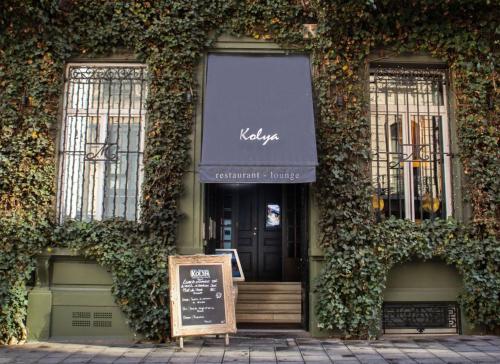 a sign in front of a building with ivy at Hotel Manos Premier in Brussels