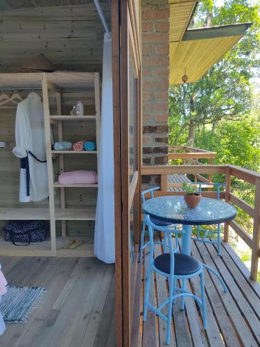 a patio with a table and chairs on a deck at Bangalô do Rio - Timbé do Sul in Timbe do Sul