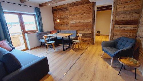 a room with a couch and a table and chairs at Alpenchalet Almrose in Auffach