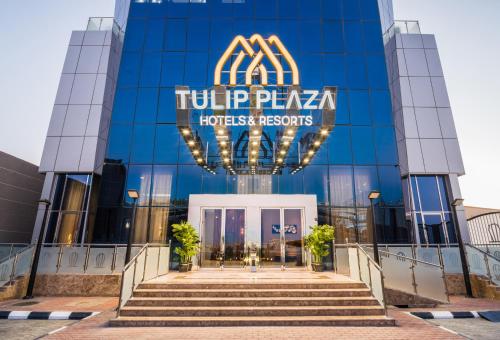 una vista de un edificio con un cartel en él en Tulip Plaza Hotel, en Sakaka