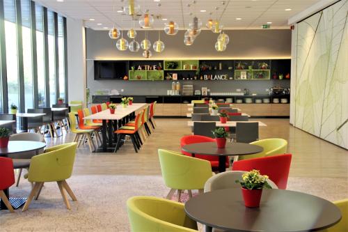 a restaurant with tables and chairs and a bar at Active Hotel in Wrocław