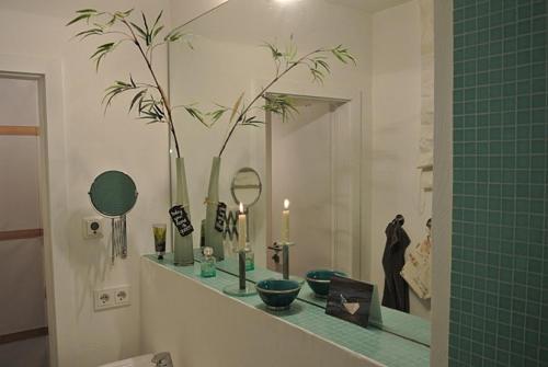 a bathroom with a counter with candles and a mirror at Wohnung Tide in Hörnum