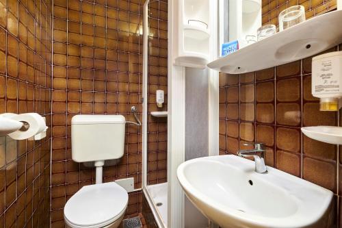 a bathroom with a toilet and a sink at Hotel Gran Vista Plava Laguna in Poreč
