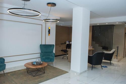 a lobby with chairs and a table and a desk at Leto Boutique Hotel Agrinio in Agrinion