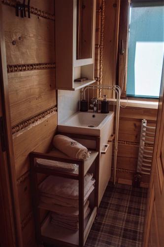 a small bathroom with a sink and a window at Wioska Jasia i Małgosi in Izdebnik