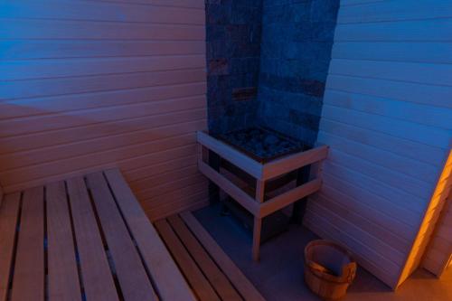 a shower in a sauna with a bench in it at Hotel Lion in Modřice