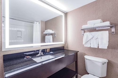 a bathroom with a sink and a toilet and a mirror at Wingate by Wyndham Lima in Lima