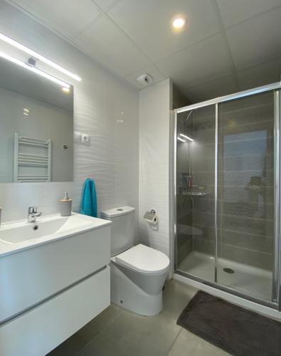 a bathroom with a toilet and a sink and a shower at Calpe Beach Sea View in Calpe