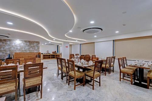 a dining room with tables and chairs in a room at Click Collection Jaipur in Jaipur
