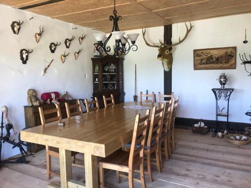 a dining room with a table and some antlers on the wall at B&B Neuses am Brand in Sonnefeld