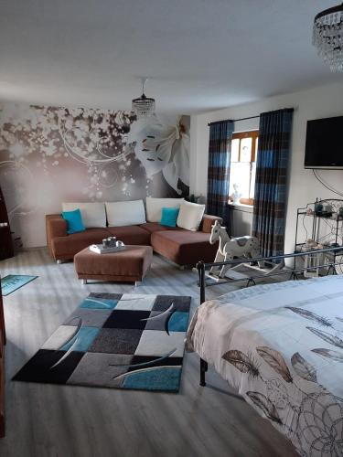 a living room with a bed and a couch at B&B Neuses am Brand in Sonnefeld