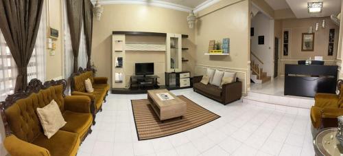 a large living room with couches and a television at Lepak-Lepak Homestay @Alor Akar Kuantan in Kuantan