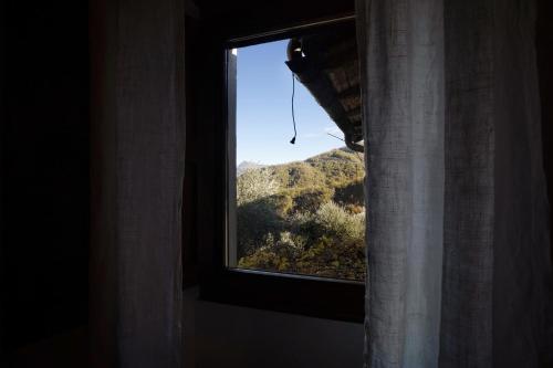 a window with a view of a mountain at Antico Granaio in Vessalico
