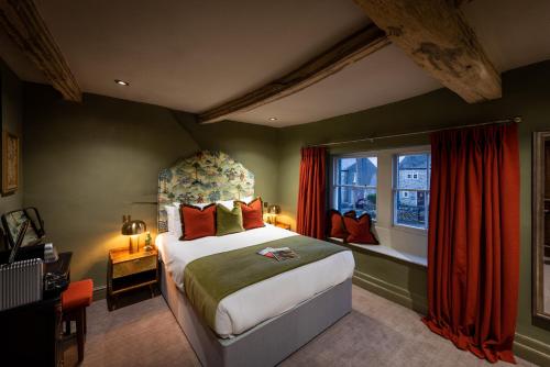 a bedroom with a large bed and a window at The Plough in Wigglesworth