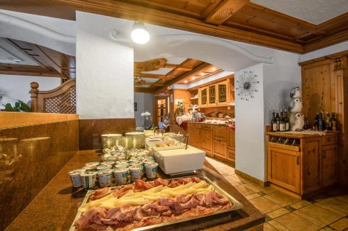 a kitchen with a counter with food on it at Pensione Camoscio in La Villa