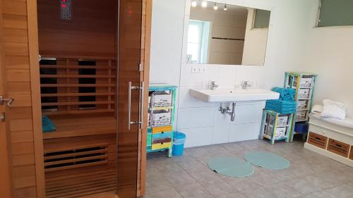 a bathroom with a sink and a mirror at Der Perweinhof in Donnersbachwald