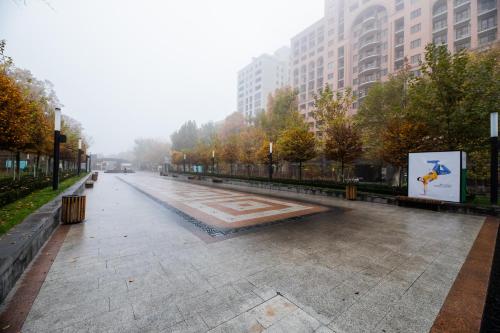 an empty street in a city with tall buildings at Diamond Hotel Yerevan in Yerevan
