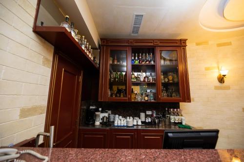 a bar in a room with alcohol bottles at Diamond Hotel Yerevan in Yerevan