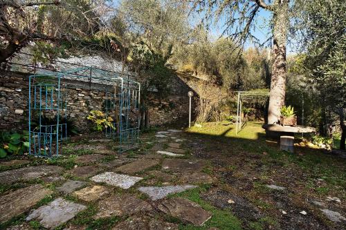 a garden with a blue gate and a bench at La Casa della nonna in Vessalico