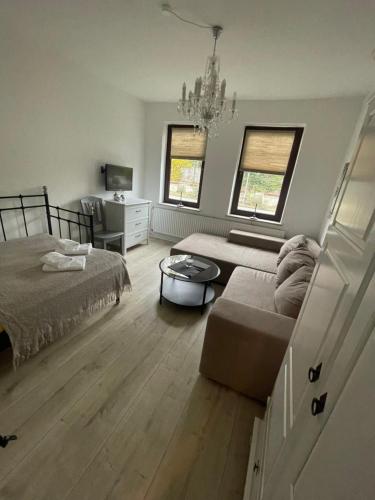 a living room with a bed and a couch at 1 Zimmer Wohnung in Strand nähe in Kiel