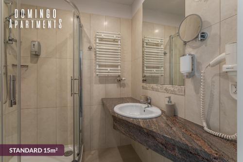 a bathroom with a sink and a shower at DOMINGO Elegant Rooms KRAKÓW Old Town in Krakow