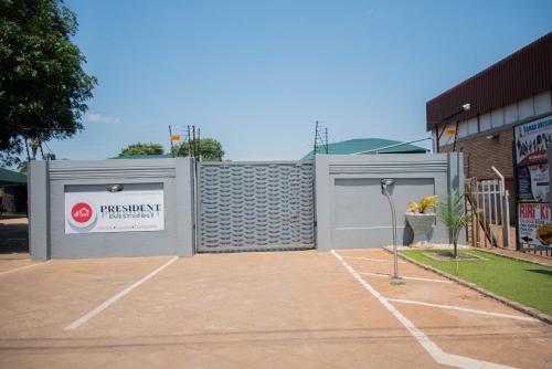a pair of garage doors in a parking lot at President Guest Lodge in Louis Trichardt