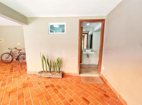 an empty hallway with a bike in a room at Pousada Villa Magna - Suite in Diamantina