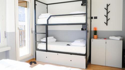 Postel nebo postele na pokoji v ubytování Hotello Hostel