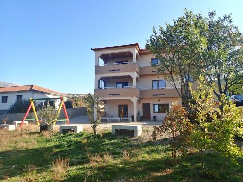 a building with a playground in front of it at APARTMAN DANE in Rovanjska