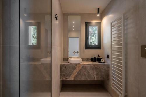 a bathroom with two sinks and two mirrors at Villa Vista Mare by iVillamia com in Villefranche-sur-Mer