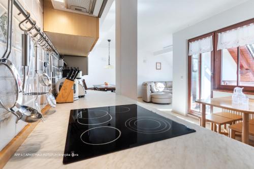 a kitchen with a black counter top in a room at Apartmaji Potepuh in Kranjska Gora