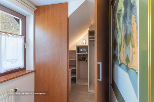 a hallway with a door and a map on the wall at Apartmaji Potepuh in Kranjska Gora