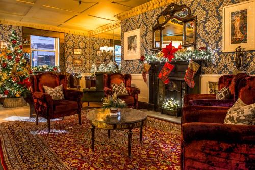 a living room filled with furniture and a christmas tree at Tralee Benners Hotel in Tralee