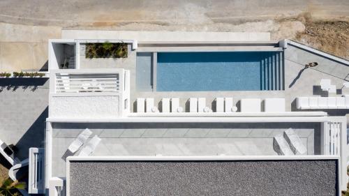 an aerial view of a house with a swimming pool at Ode Iconic Residence, forever in blue, By ThinkVilla in Balíon