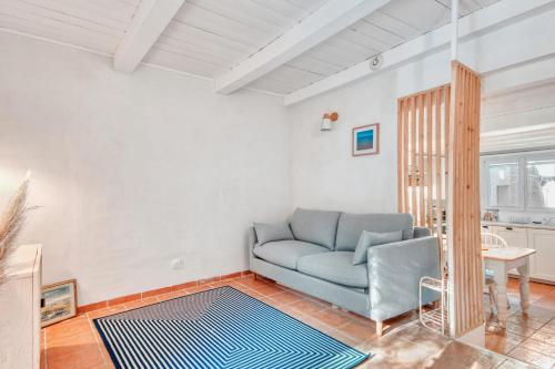 uma sala de estar com um sofá azul e uma mesa em Le Mazet Doré - Welkeys em Sanary-sur-Mer